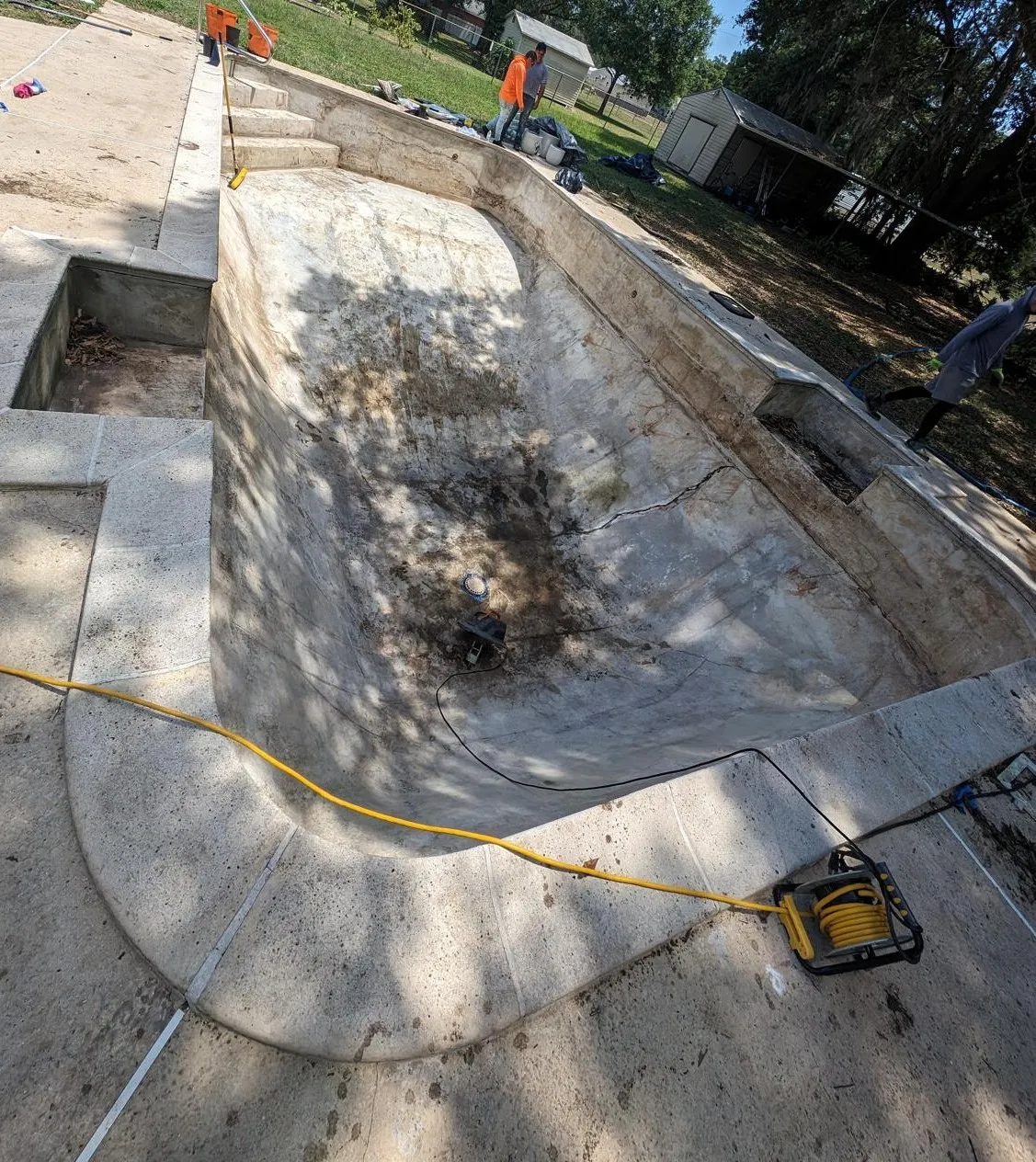 The empty swimming pool completely clean and dry ready for the new liner installation