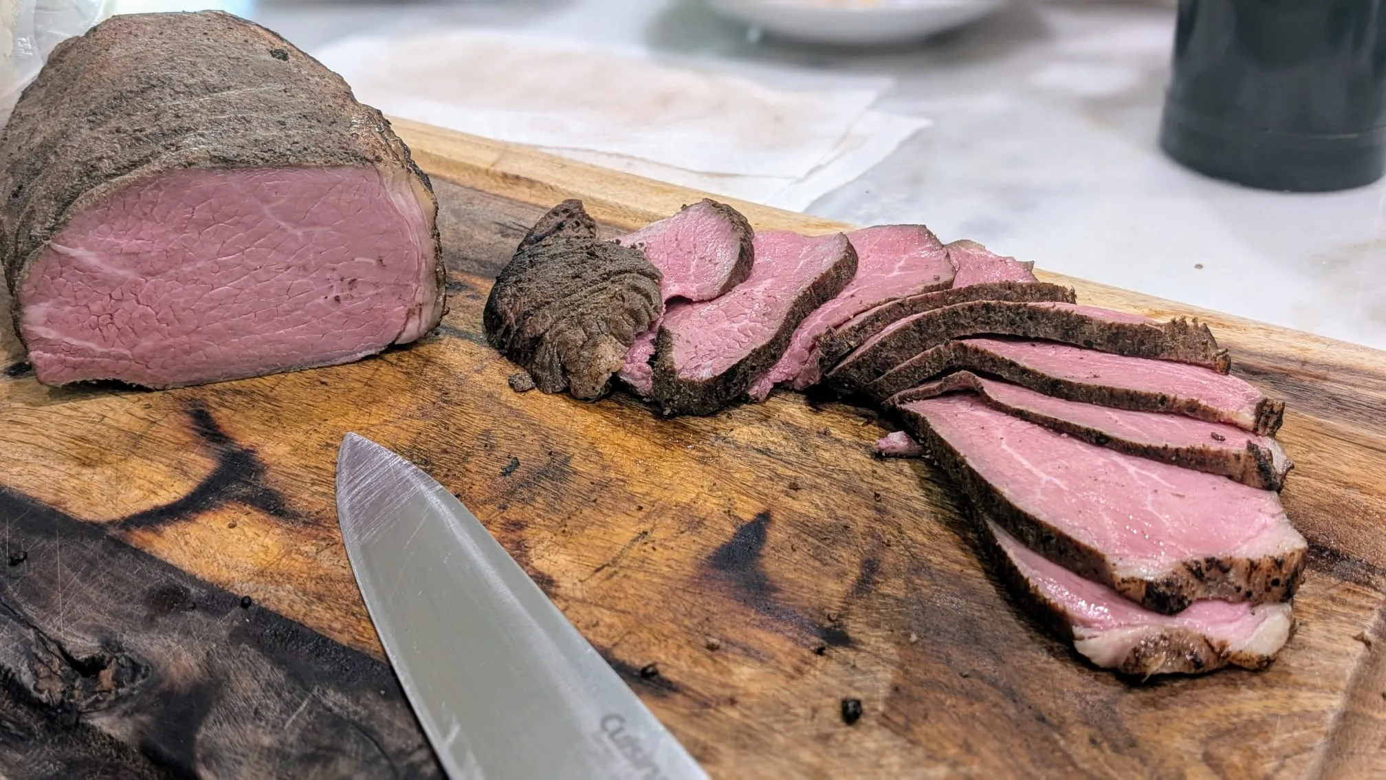The final sliced premium beef steak garnished with fresh garden rosemary